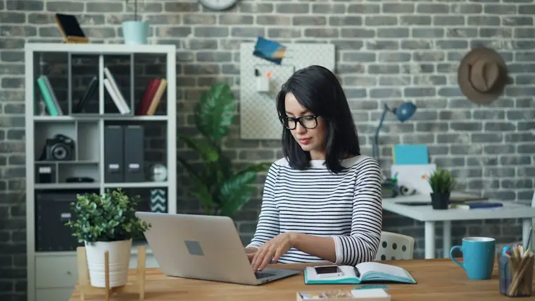 Professional working through a plan on a laptop