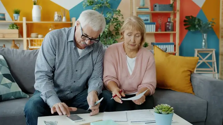 Older couple reviewing documents together at home