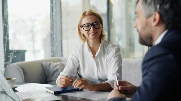 Couple reviewing finances with a laptop at a table