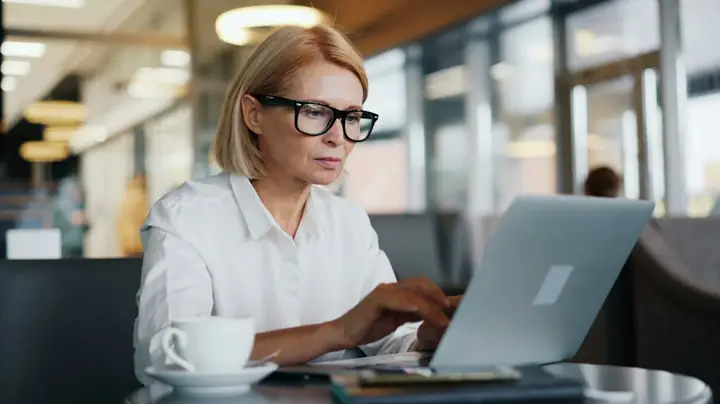 Accountant reviewing figures on a laptop in a bright office