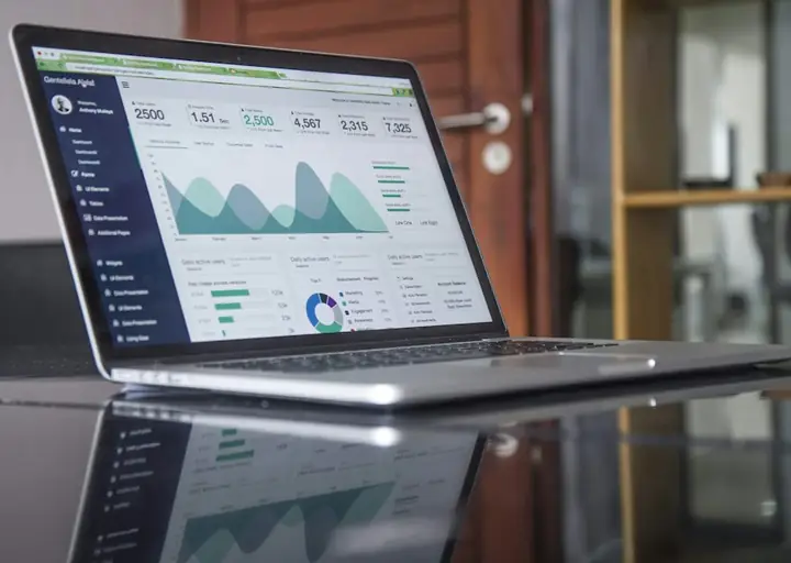 Laptop showing a financial dashboard on a desk